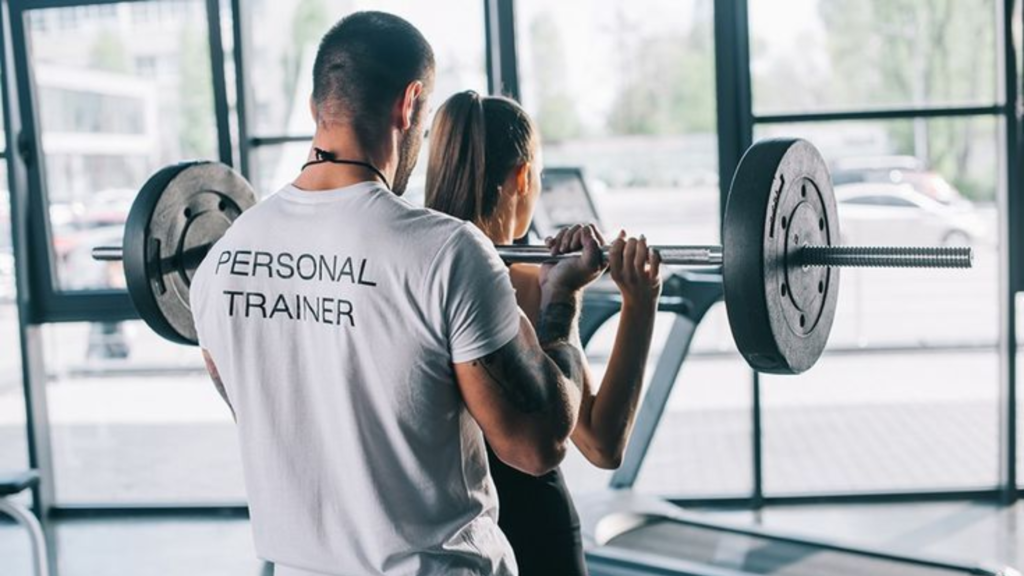 Personal Trainer guiding a gym workout compared with self-guided training