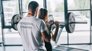 Personal Trainer guiding a gym workout compared with self-guided training
